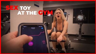 Ragazza sexy che si allena con un sex toy telecomandato in una palestra pubblica