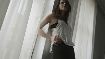 A schoolgirl takes off her clothes