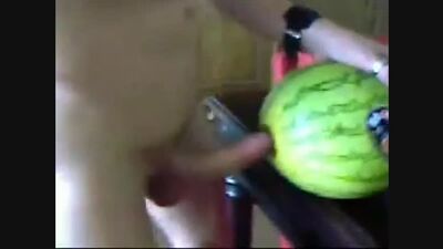 A guy is having sex with a watermelon