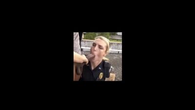 A policewoman is giving a blowjob